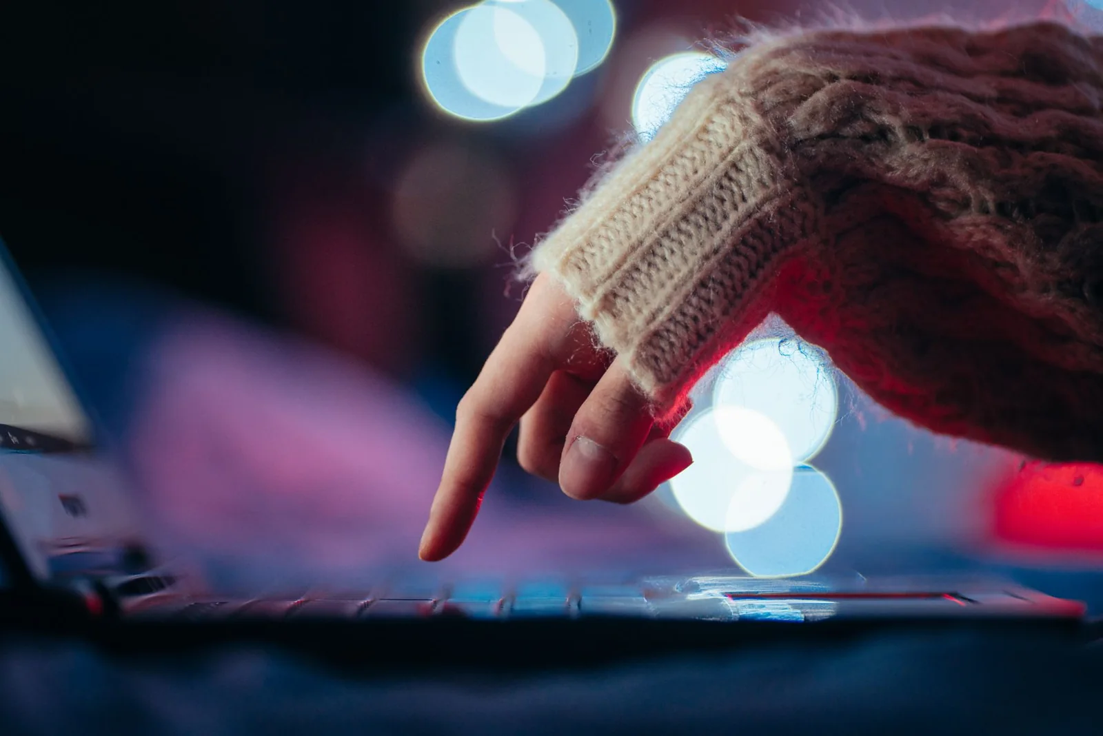 A hand using a laptop keyboard in the Philippines